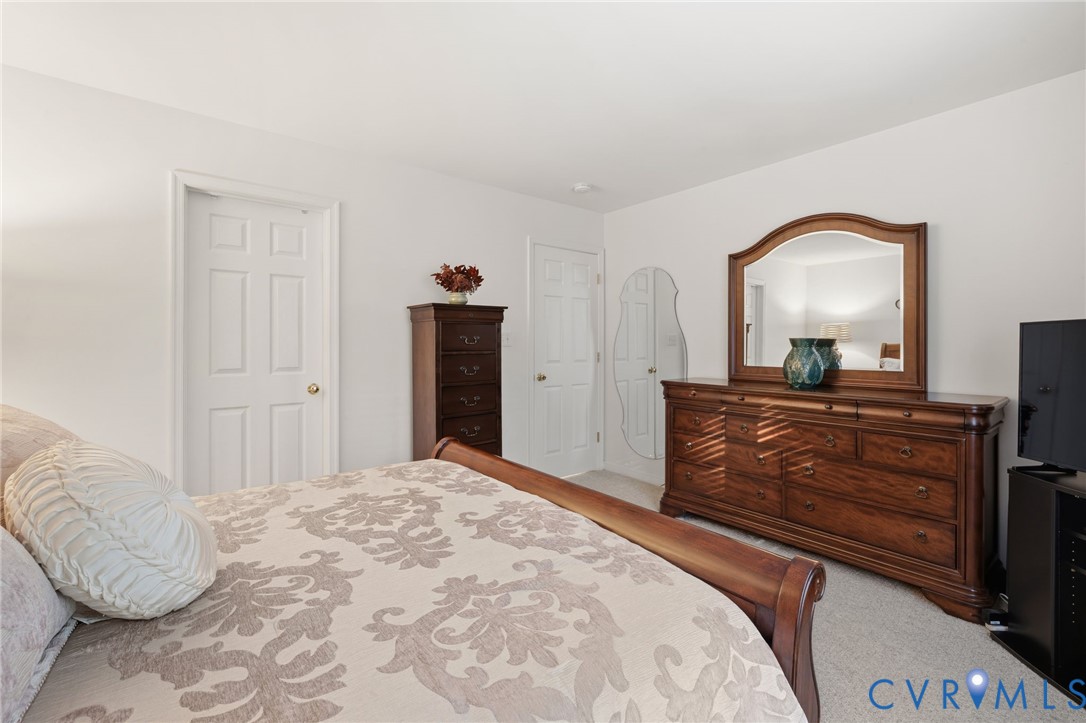 Neutral-toned interior featuring wall-to-wall carpeting and multiple six-panel interior doors