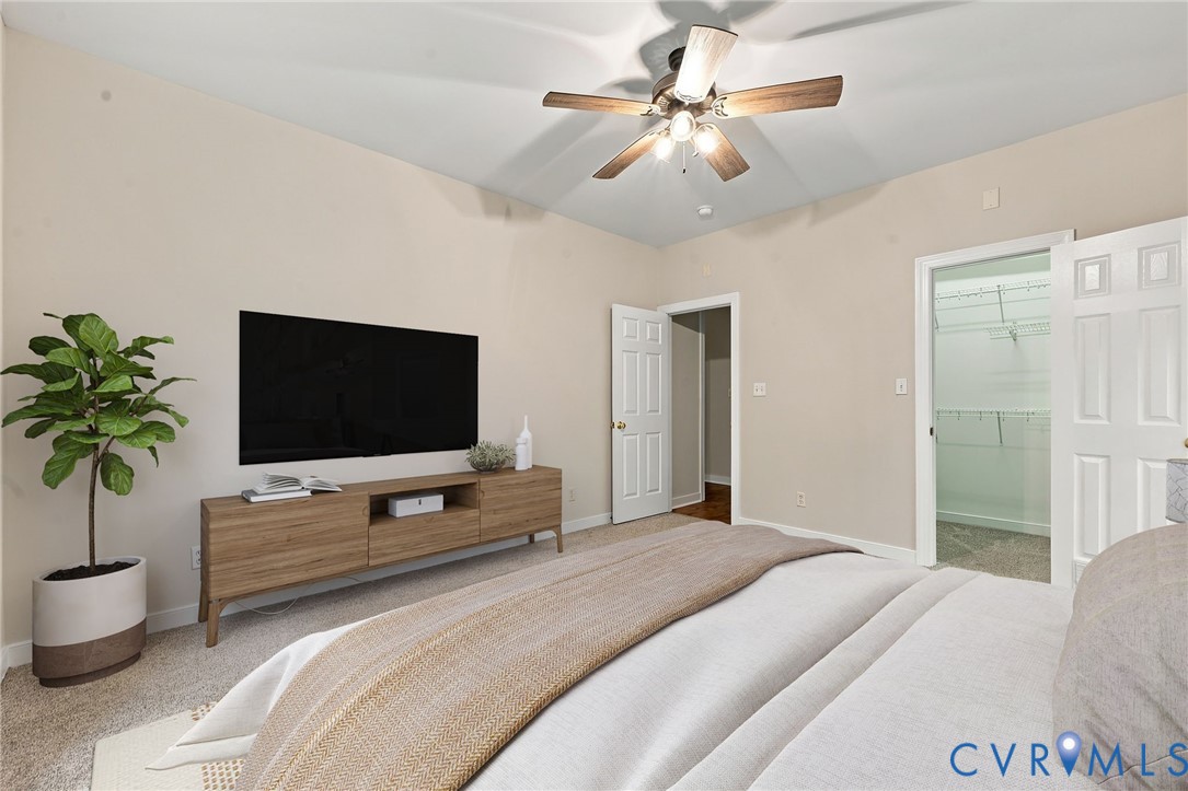 Guest bedroom with neutral paint and ceiling fan. Virtually staged concept