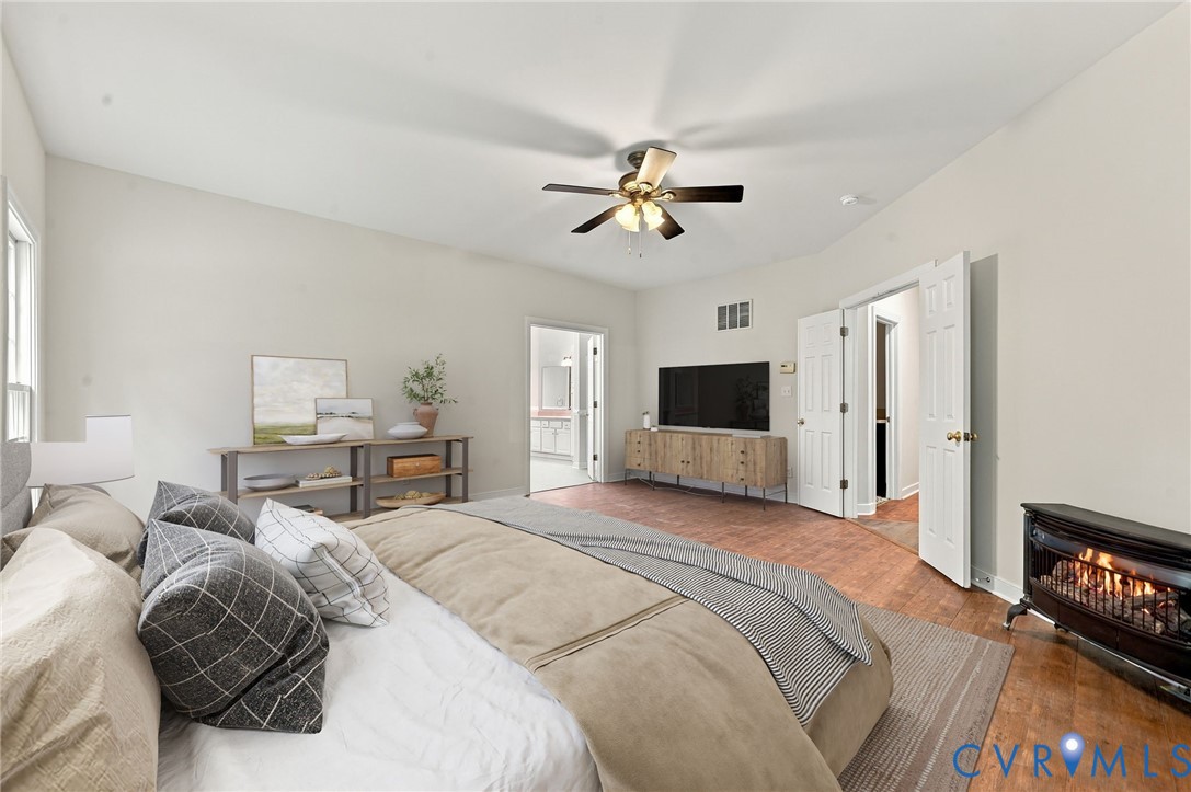 Primary bedroom with LVP floors. Virtually staged concept