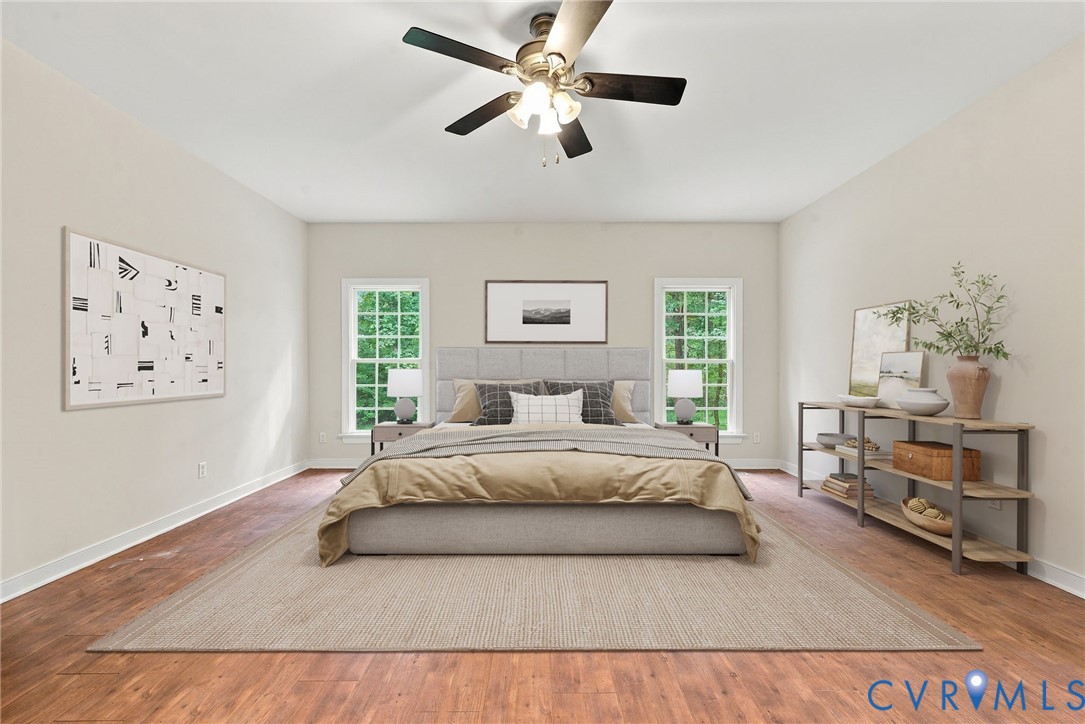 Primary bedroom with LVP floors. Virtually staged concept