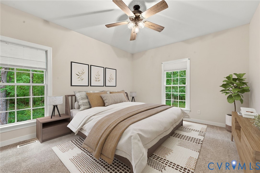 Guest bedroom with neutral paint and ceiling fan. Virtually staged concept