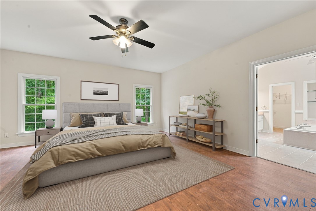 Primary bedroom with LVP floors. Virtually staged concept