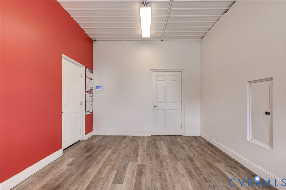 Wood-finish flooring, high ceilings, recessed linear lighting, two interior doors, and a built-in electrical panel enclosure Wood-finish flooring, high ceilings, recessed linear lighting, two interior doors, and a built-in electrical panel enclosure
