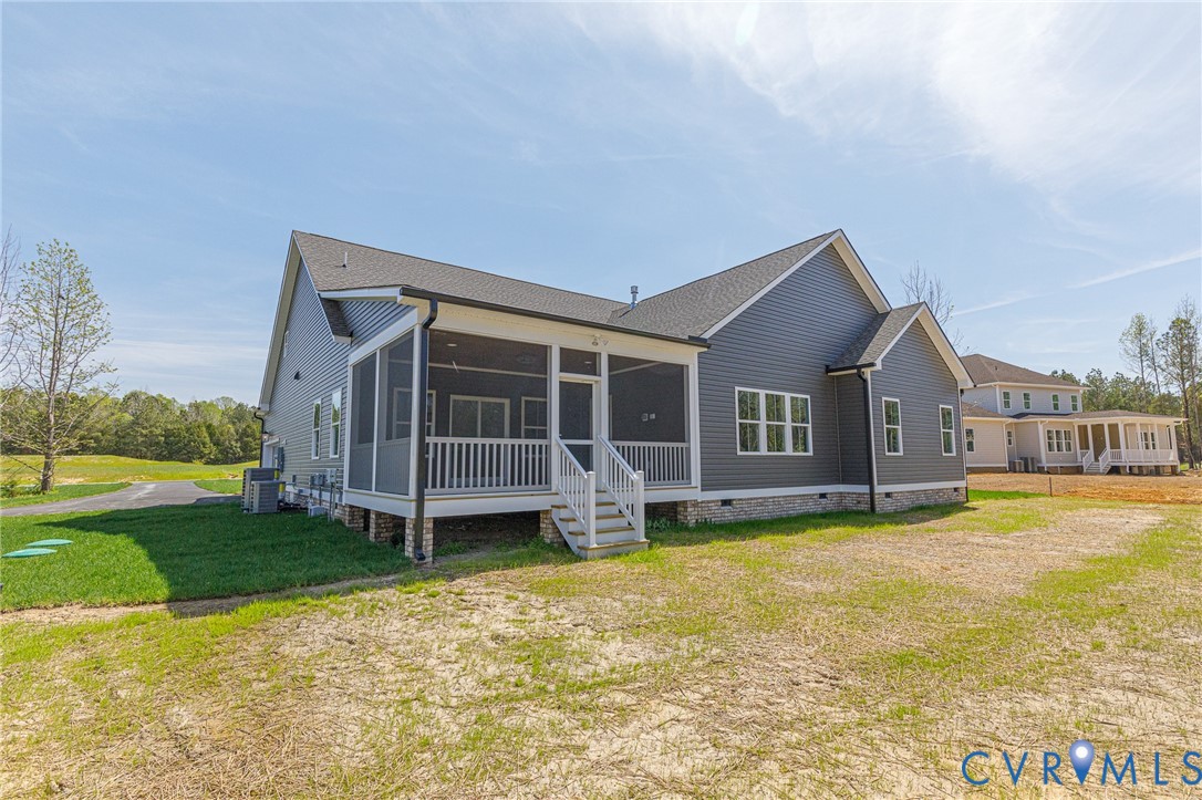 This property features a screened porch with white railings, a grey exterior with white trim, and a dark shingled roof