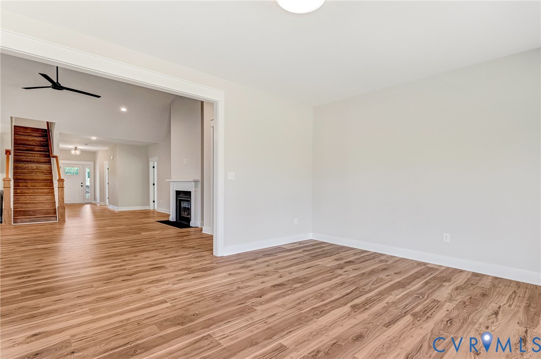 The property features hardwood floors throughout, with bright white walls and trim