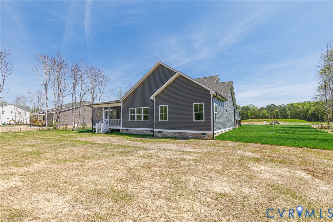 The property features a dark gray exterior with light trim windows and a visible covered porch