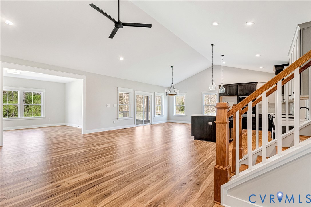 The property features hardwood floors, a vaulted ceiling, and recessed lighting