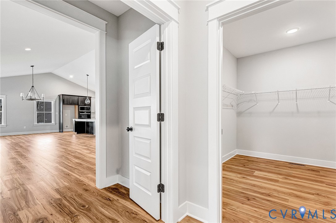 This property features wood flooring throughout, white interior doors, and a spacious closet with wire shelving