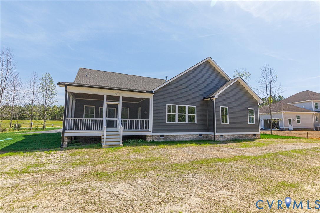 The property features a screened-in porch with white railings and steps, and a dark grey exterior with white trim