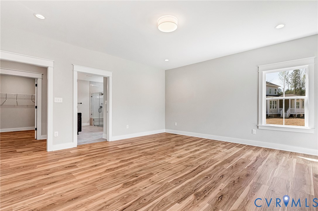Bright interior room featuring wood-look flooring, light-colored walls, and recessed lighting