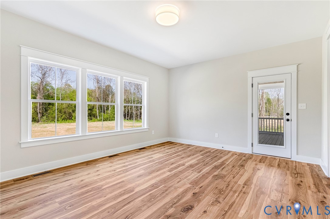 This room features hardwood flooring, white walls, and a recessed ceiling light