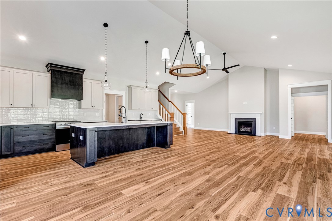 The property features an open-concept living space with hardwood flooring and vaulted ceilings