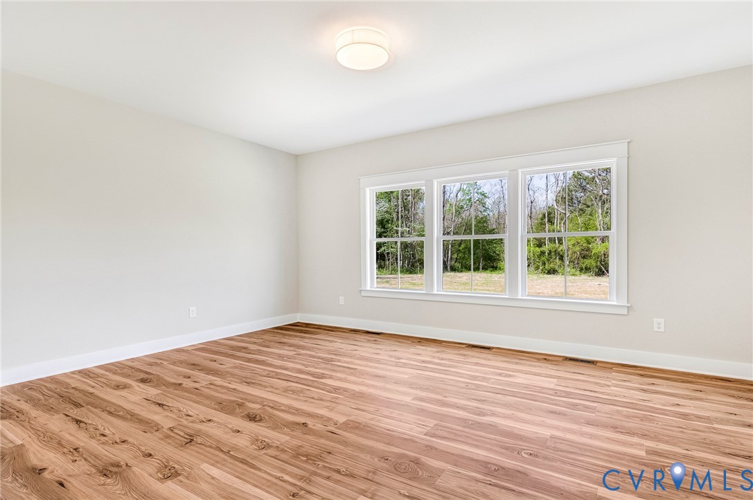 The property features light-colored walls, wood flooring, and a ceiling light fixture