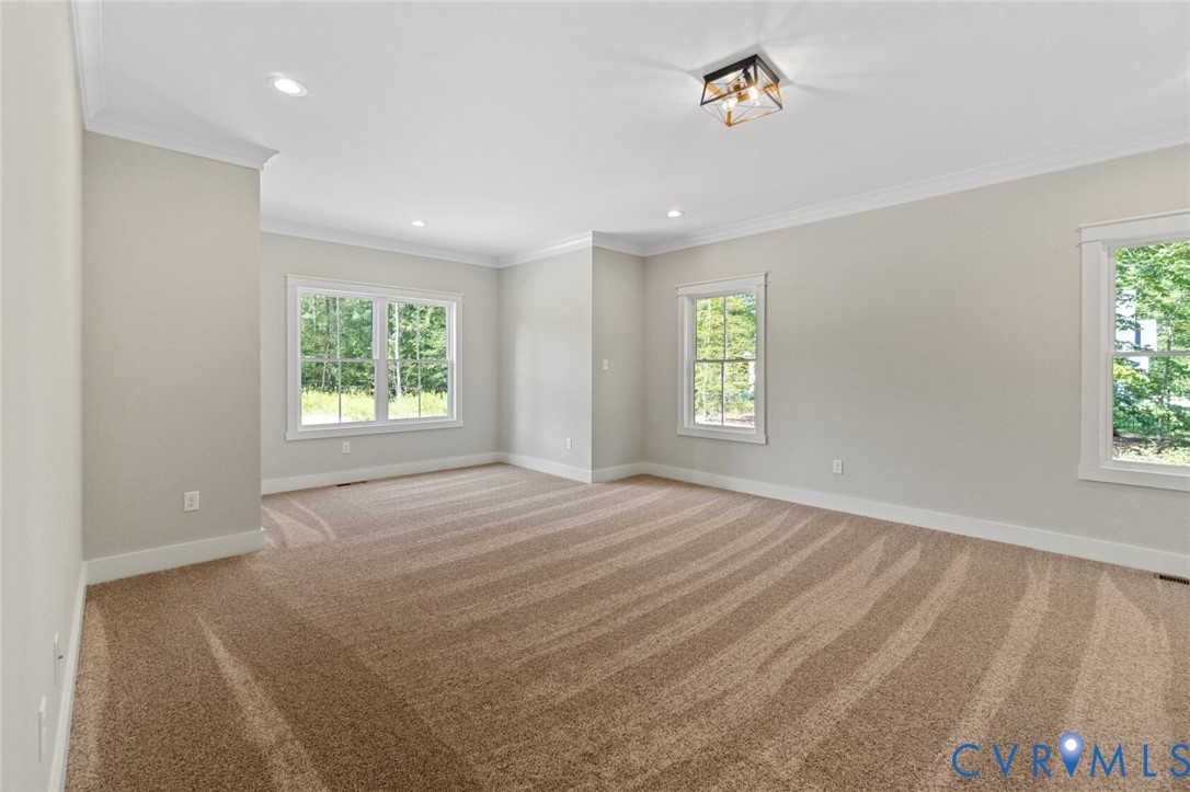 Neutral wall palette with crown molding, plush carpeting, recessed lighting, and a geometric flush-mount light fixture