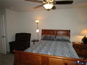 Room interior featuring a ceiling fan with integrated lighting and a multi-panel door