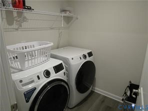 Laundry closet featuring wood-finish flooring and integrated wire shelving