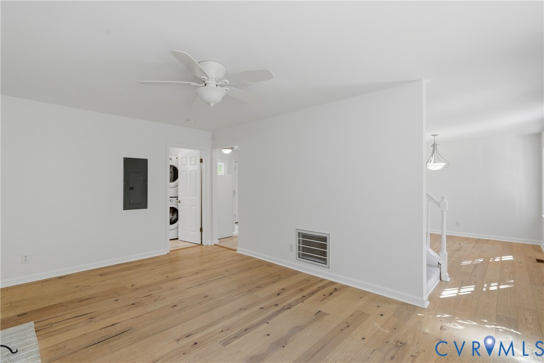 Wood-finish flooring, white ceiling fan, and recessed ceiling lighting