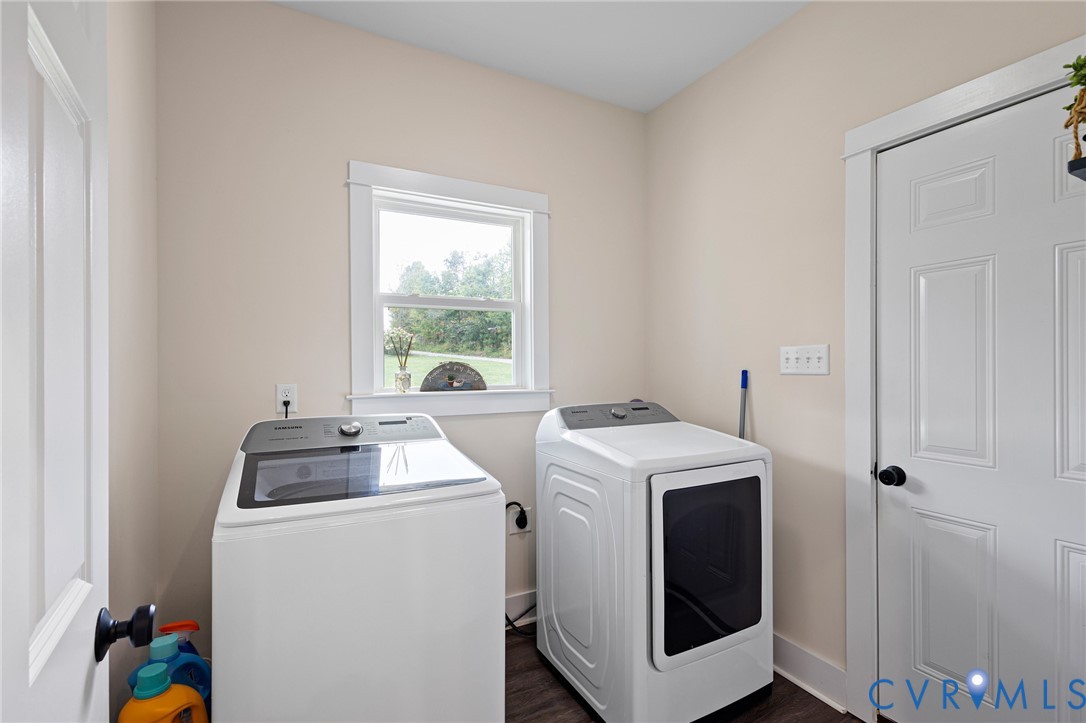Utility area featuring wood-finish flooring, a single-hung window with casing, and a six-panel interior door