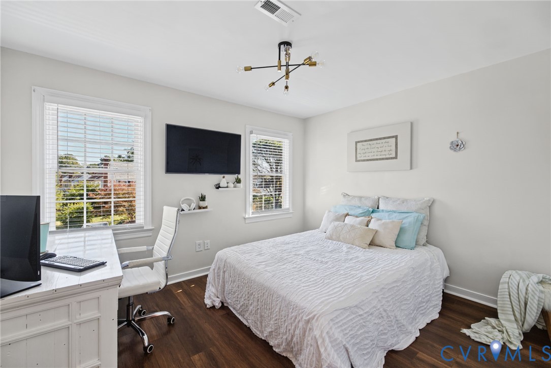 Wood-finish flooring, multi-pane windows, and a multi-arm geometric ceiling fixture