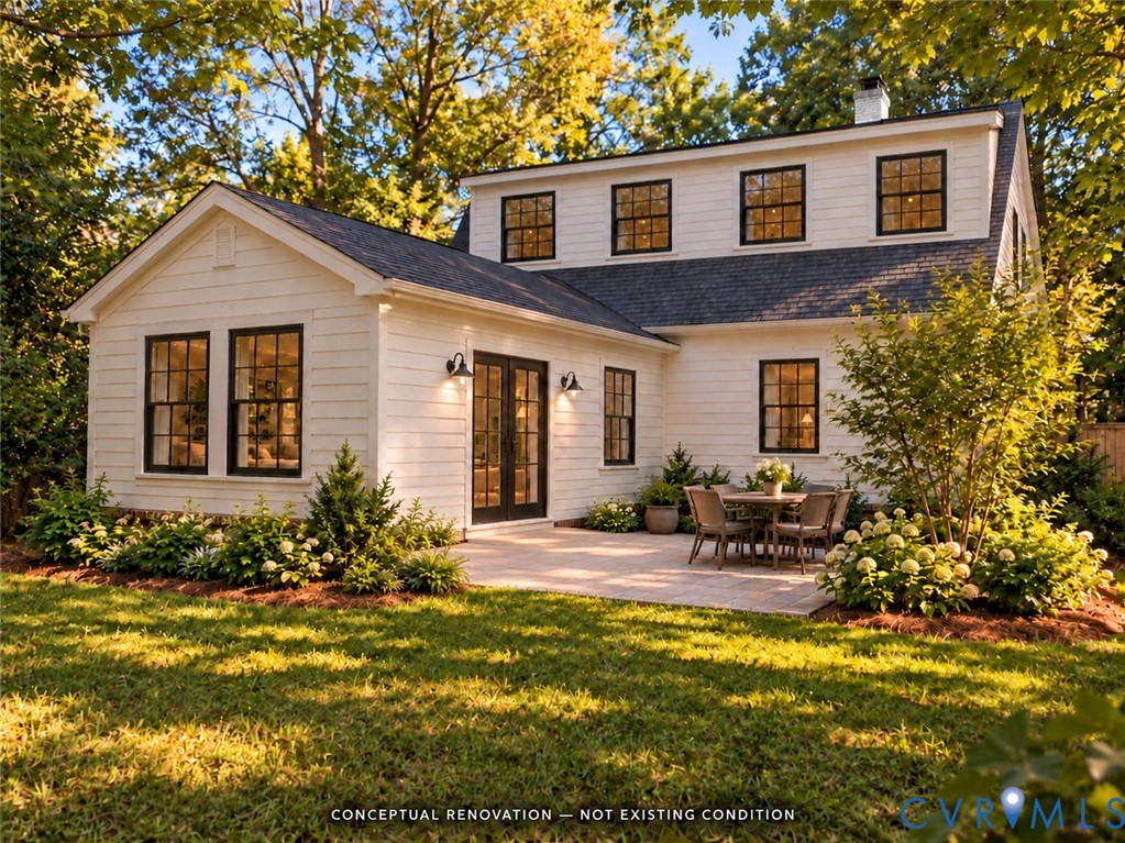 White horizontal siding exterior featuring dark-framed windows, double glass doors, a stone patio, and an asphalt shingle roof