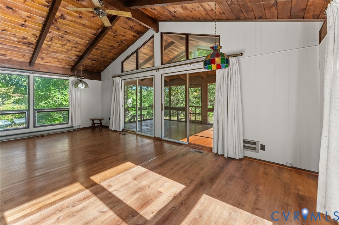 Light & bright Great Room with vaulted, exposed cedar-beamed ceiling, wood floors, ceiling and & dining area. View of Kinsale Creek from Great Room.