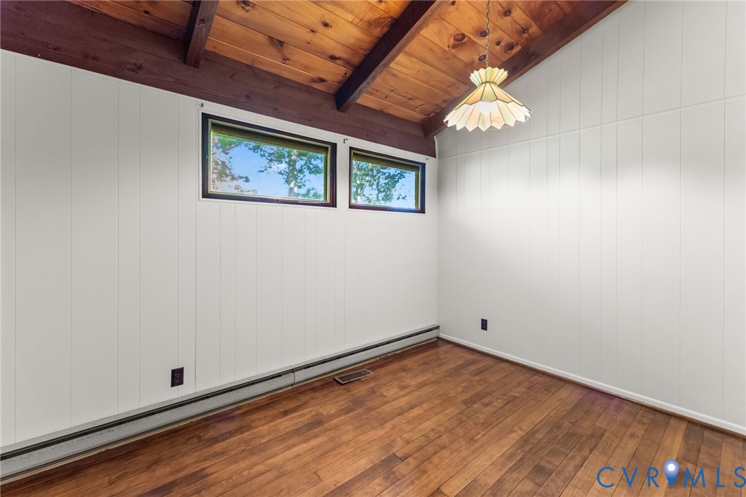 3rd Bedroom with vaulted, exposed cedar-beamed ceiling & wood floors.