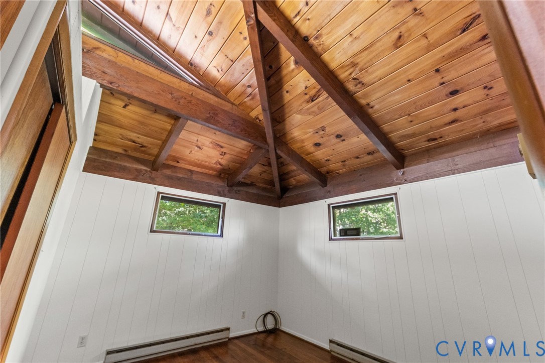 2nd Bedroom with vaulted, exposed cedar-beamed ceiling & wood floors.