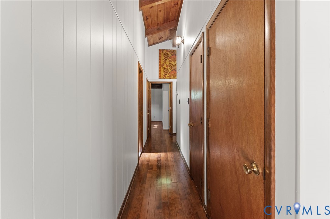Hallway with wood flooring.