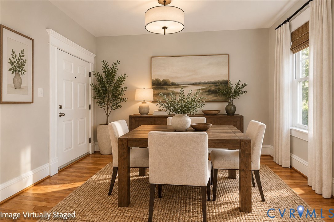 Hardwood flooring, multi-pane window with interior casing, and a drum-style ceiling light fixture