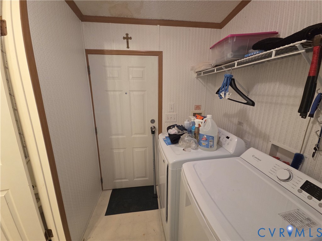 Laundry area featuring paneled walls, a six-panel exterior door, and built-in wire shelving