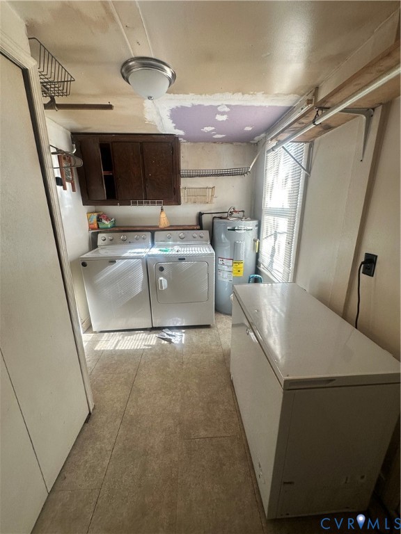 Utility area featuring neutral tile flooring, wall-mounted wooden cabinetry, and a window for natural light