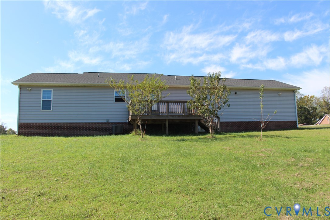 Exterior featuring horizontal siding, a masonry foundation, and a raised wooden deck