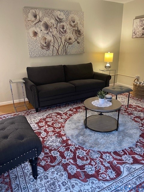 Interior room featuring neutral-toned wall paint and wood-finish flooring