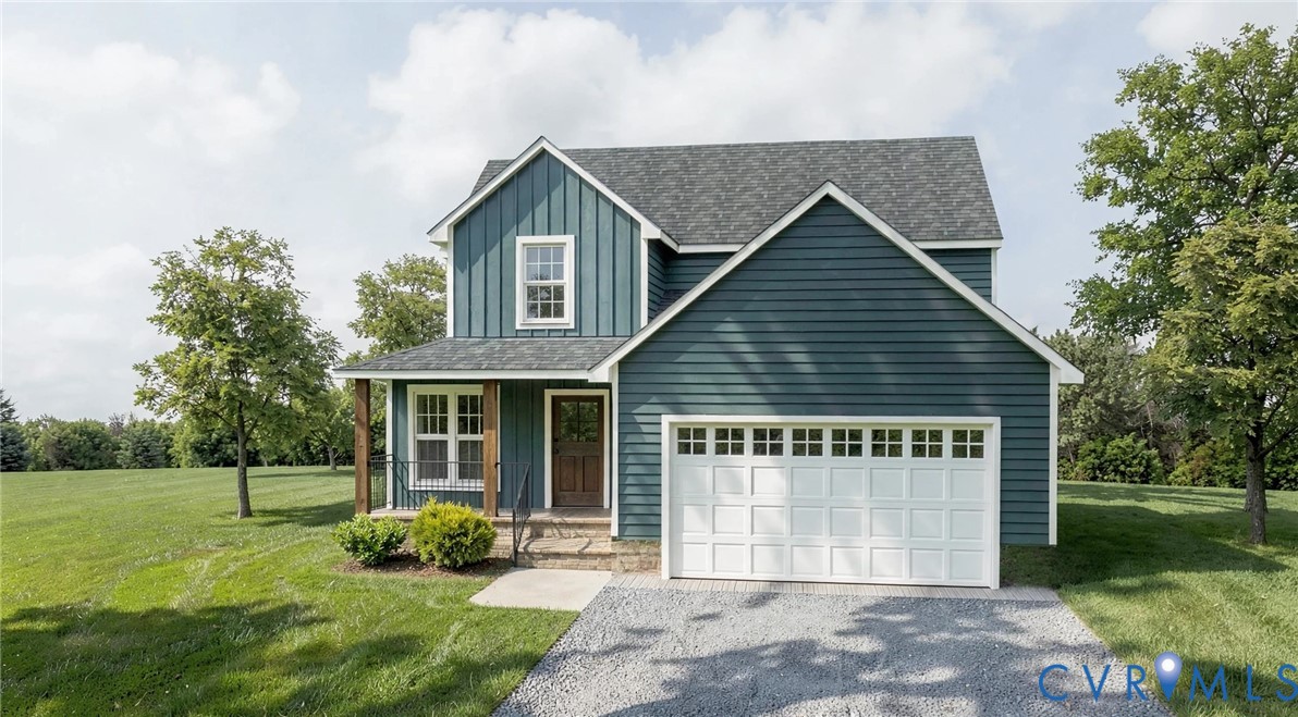 Two-story home with a blue vertical and horizontal siding exterior, a front-facing attached two-car garage with white paneled doors, and a covered front porch featuring wood-post supports