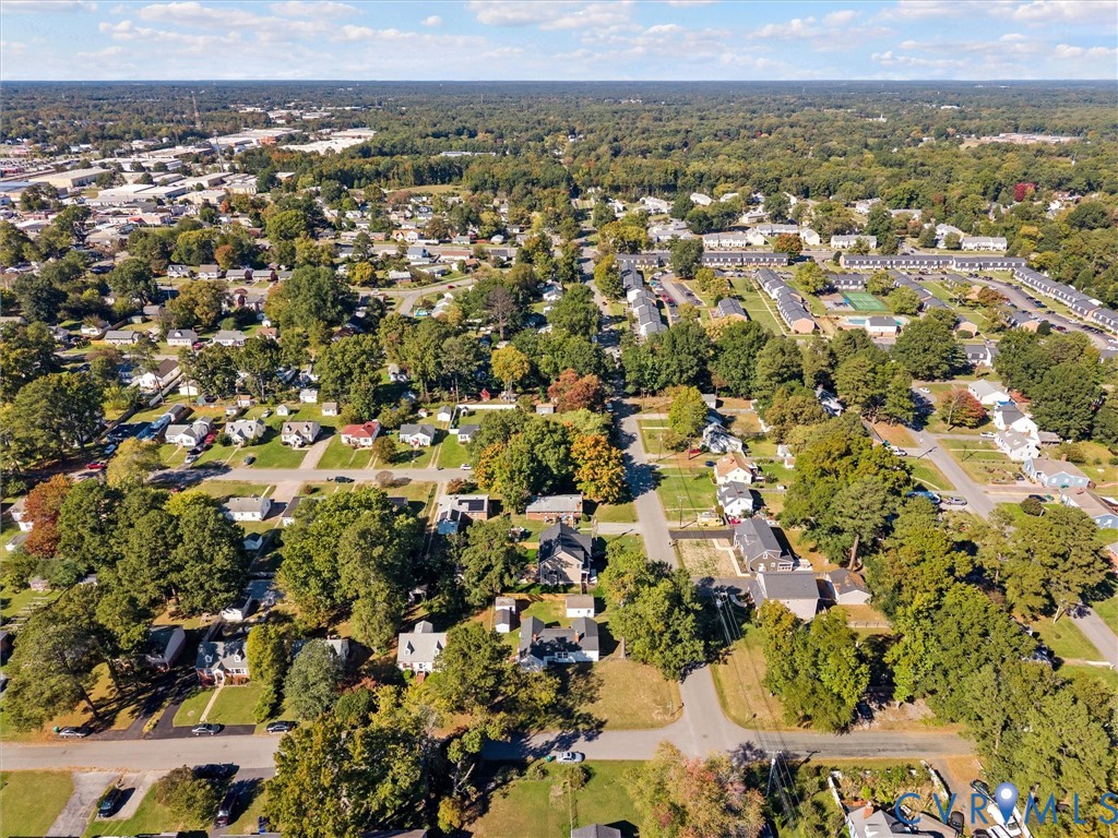 Aerial perspective of the residential area featuring established tree canopy, grid-pattern street layout, and suburban landscaping