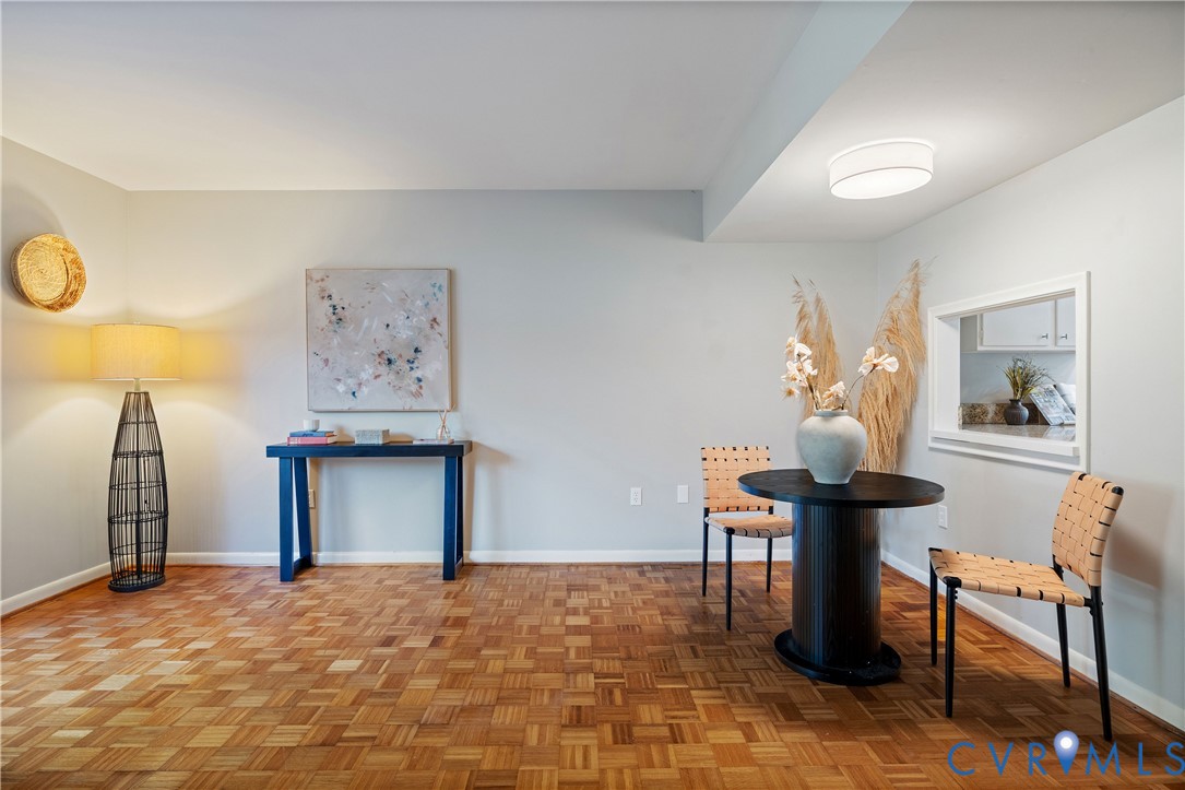 Parquet wood-finish flooring, ceiling-mounted dome light fixture, and interior pass-through opening