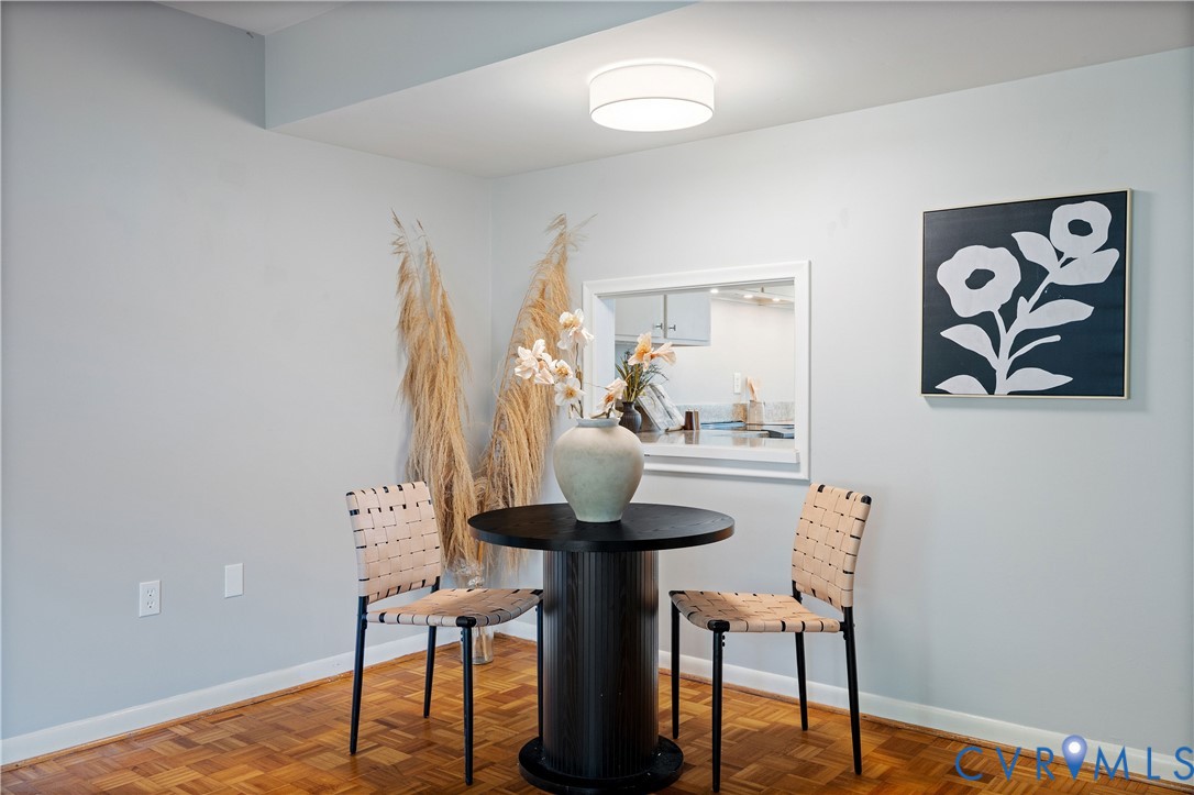 Parquet wood-finish flooring, ceiling-mounted drum light fixture, and interior pass-through opening