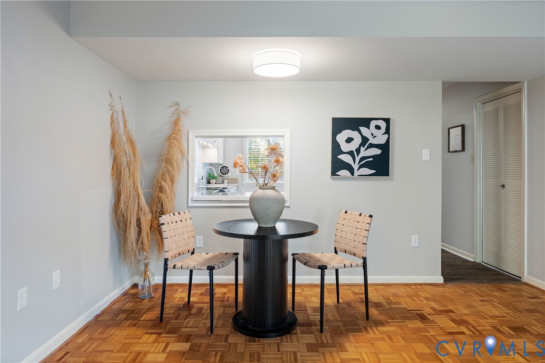 Parquet wood-finish flooring, recessed wall opening with white casing, and flush-mount ceiling lighting