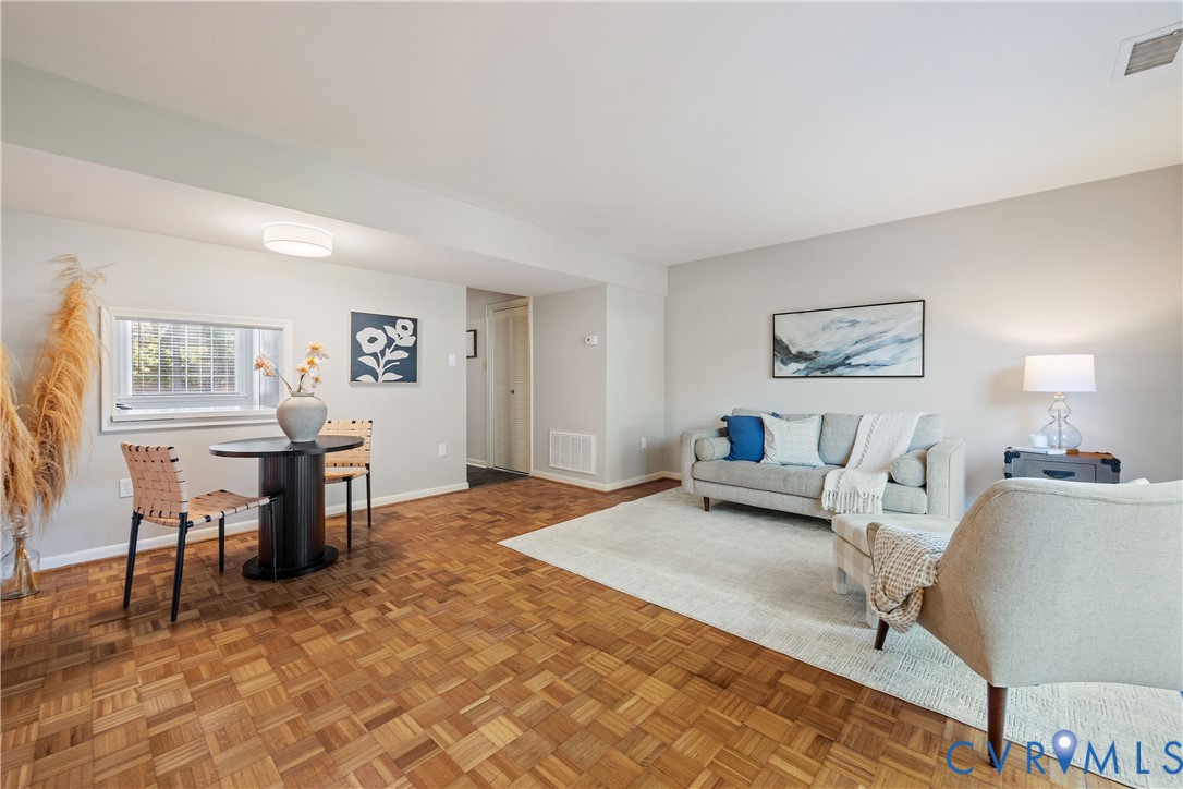 Parquet wood-finish flooring, neutral wall paint, recessed ceiling light, and horizontal window