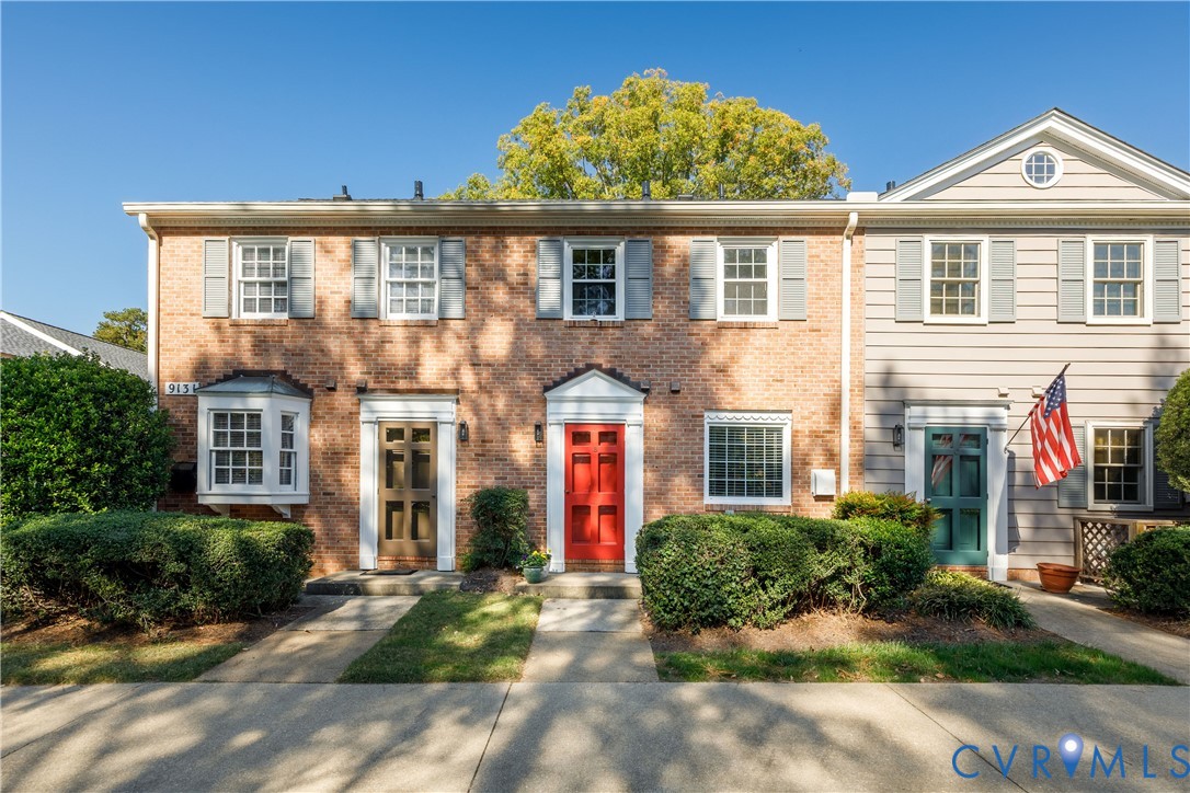 Multi-story exterior featuring a brick facade with horizontal siding, paneled front doors, multi-light windows, and a pedimented entryway Multi-story exterior featuring a brick facade with horizontal siding, paneled front doors, multi-light windows, and a pedimented entryway