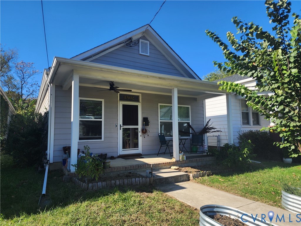 Craftsman-style exterior featuring horizontal siding, a covered front porch with square columns, a mounted ceiling fan, and masonry detailing Craftsman-style exterior featuring horizontal siding, a covered front porch with square columns, a mounted ceiling fan, and masonry detailing