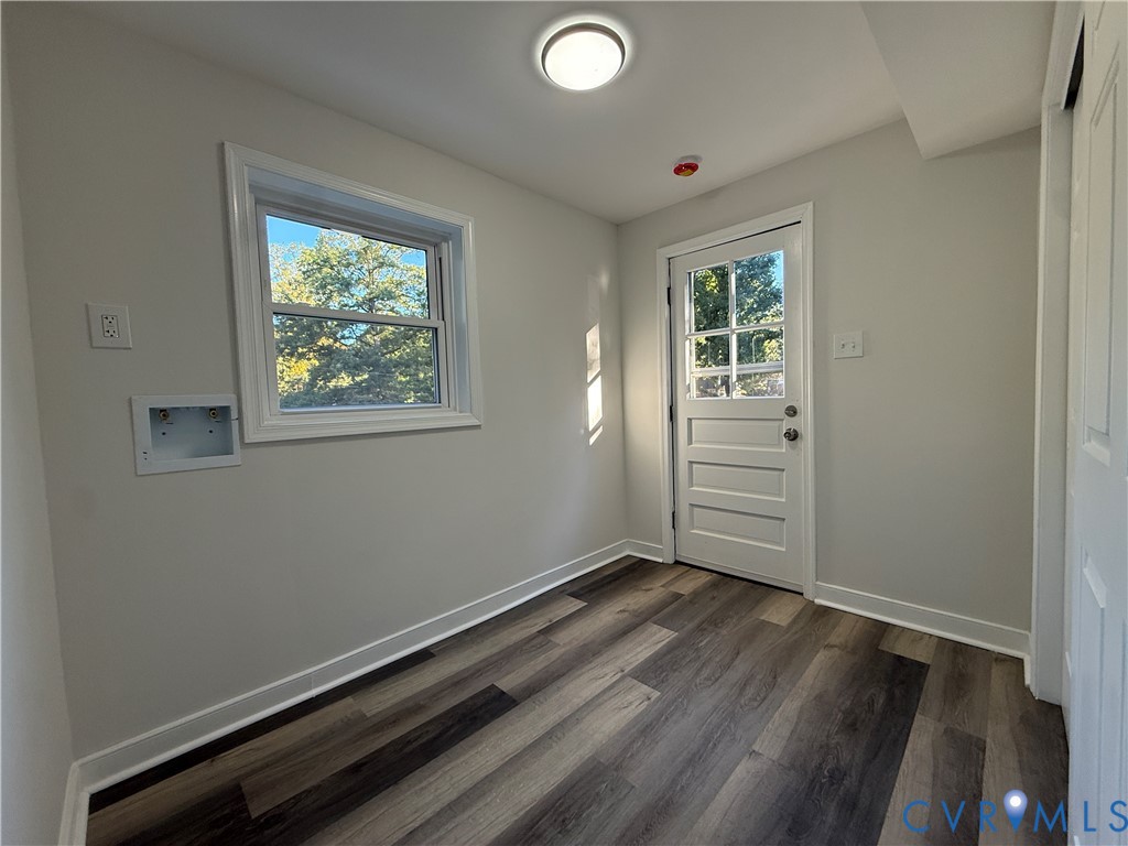 Wood-finish flooring, multi-pane exterior door, recessed laundry hookups, and dual-pane window