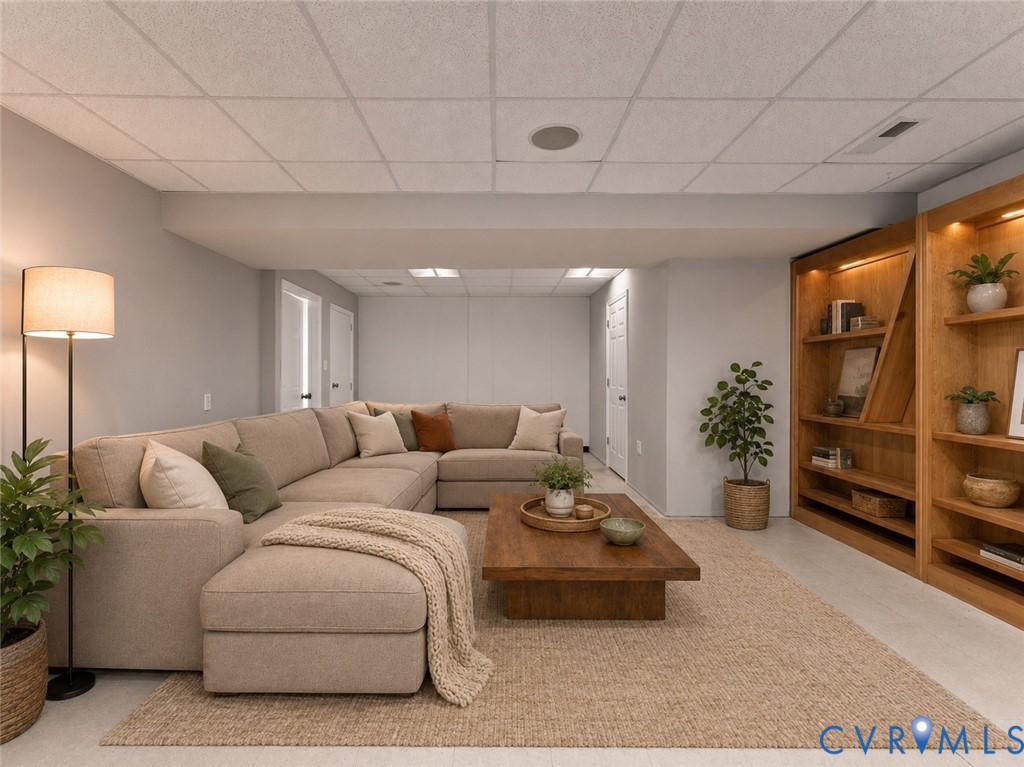 Interior space featuring light-toned walls, recessed lighting, and built-in wood shelving with integrated display illumination