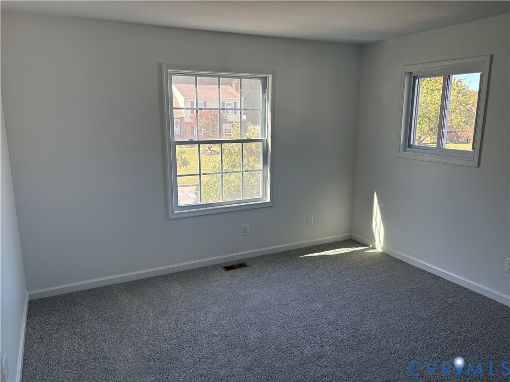 Bedroom 3 featuring neutral-toned carpeting and double-hung windows with exterior grid muntins