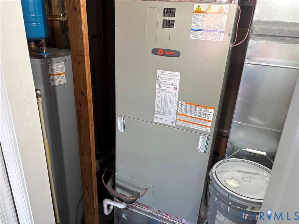 Trane furnace unit paired with a dedicated water heater featuring metal ductwork