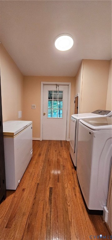 Utility room featuring wood-finish flooring, a flush-mount ceiling light, and an exterior door with a window insert