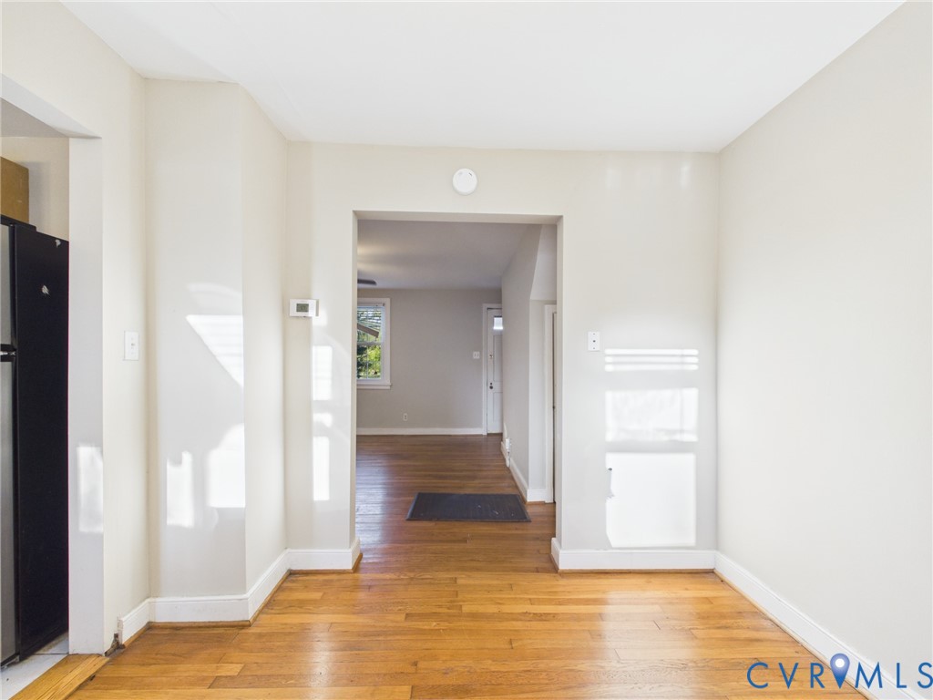 Neutral-toned interior featuring wood-finish flooring and a rectangular entryway
