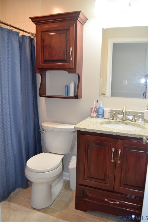 Upstairs full hall bath with counter-height custom vanity with granite countertop.