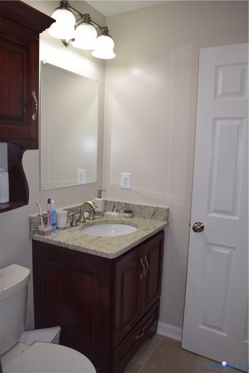 Upstairs full hall bath with counter-height custom vanity with granite countertop.