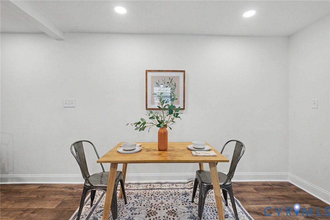 Neutral walls paired with wood-finish flooring and recessed ceiling lighting